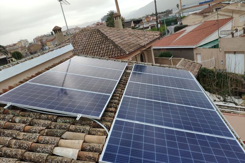 Solar installers working on a rooftop photovoltaic array